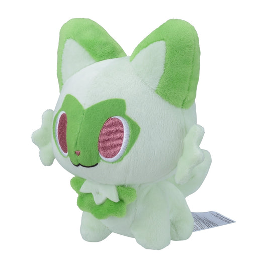 A round, chibi-style plush of Sprigatito with large pink eyes, pale green fur, and darker green accents on its face, ears, and collar.